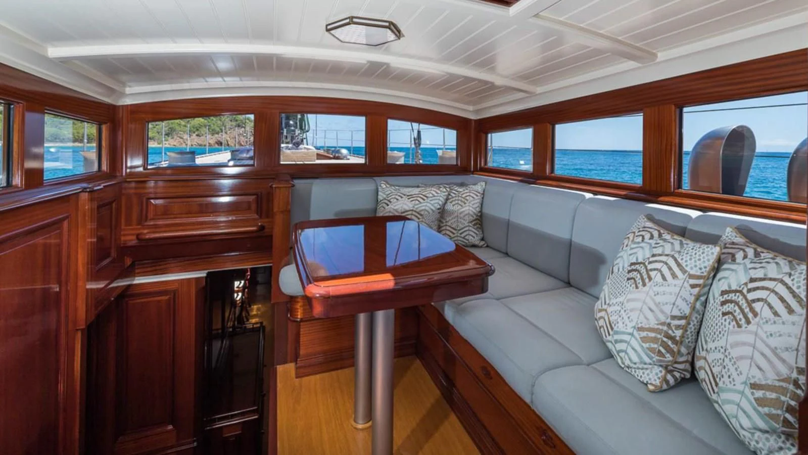 a room with a couch and a table aboard RAINBOW Yacht for Sale