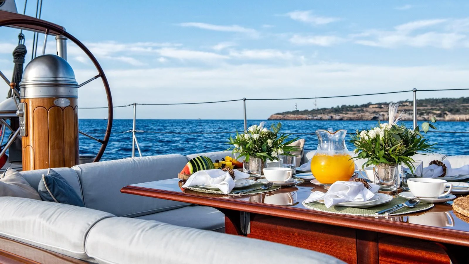 a table with food and drinks on it aboard RAINBOW Yacht for Sale