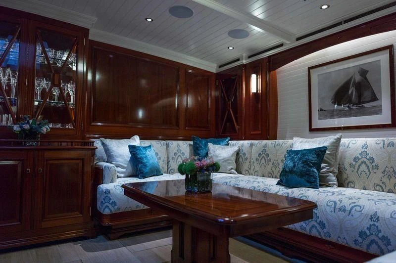 a living room with a couch and a table aboard RAINBOW Yacht for Sale