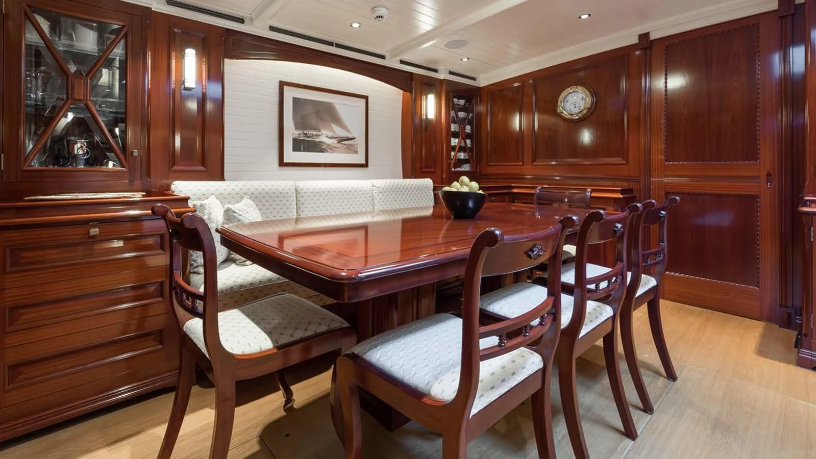 a dining table and chairs in a room aboard RAINBOW Yacht for Sale