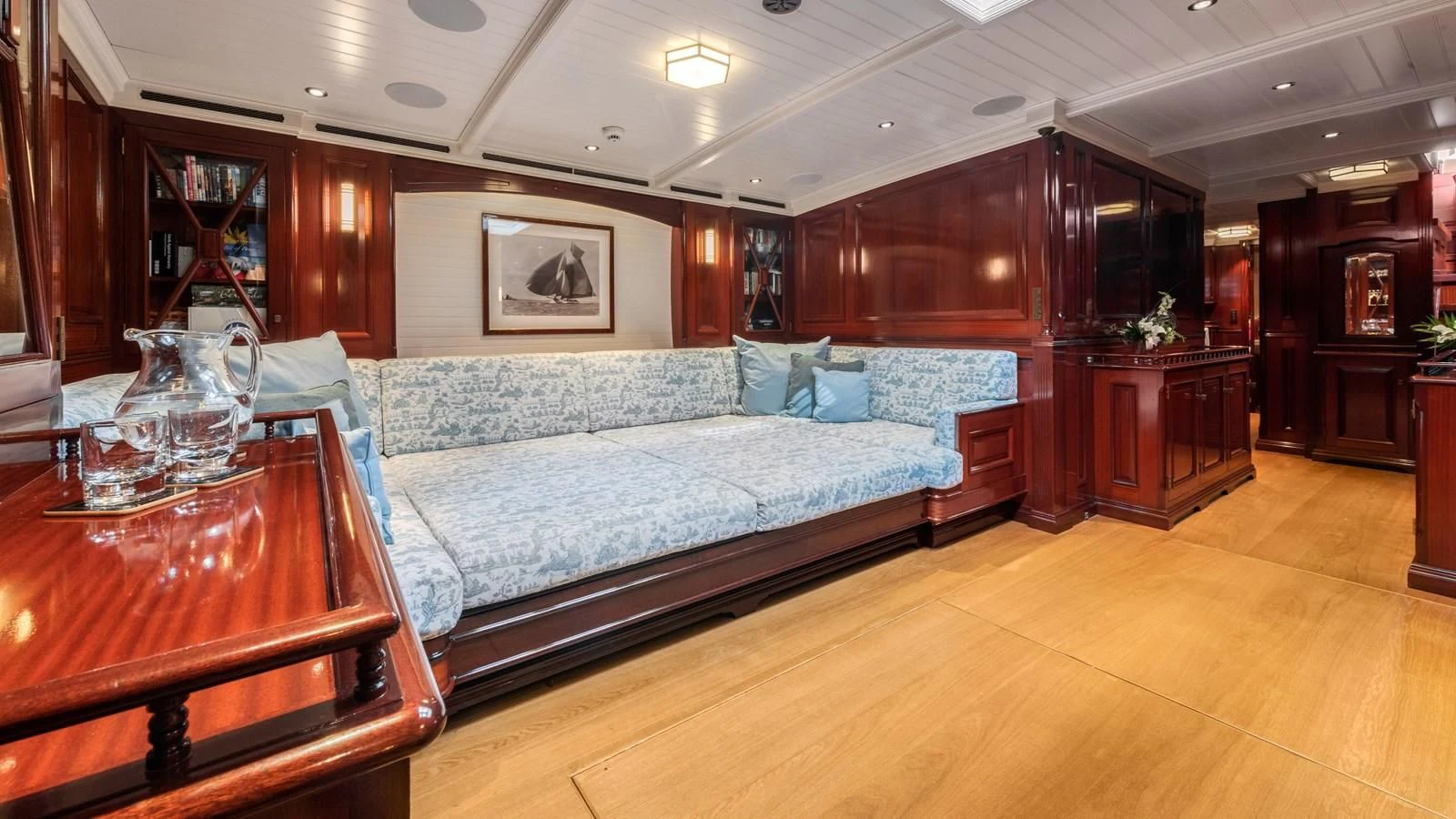 a large bedroom with a bed and a table aboard RAINBOW Yacht for Sale