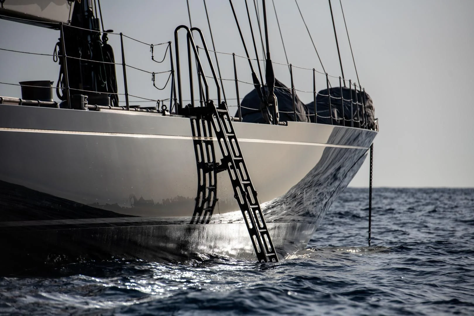 a large white boat with a large tail and a large tail fin in the water aboard RAINBOW Yacht for Sale