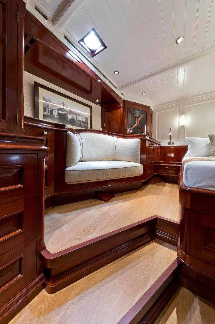 a room with a couch and a bed aboard RAINBOW Yacht for Sale