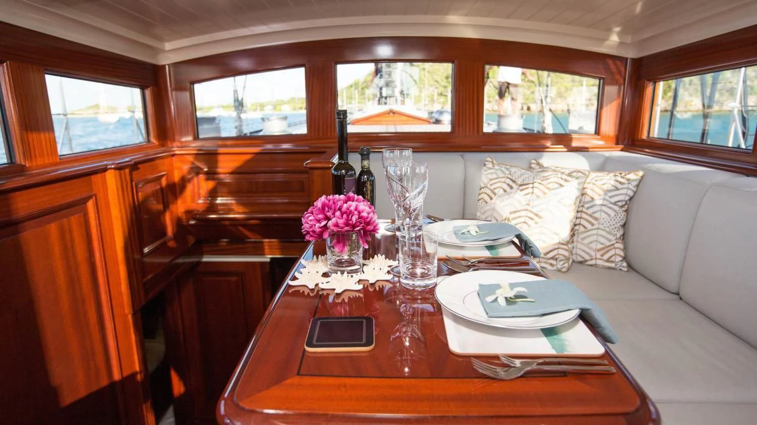 a table with a plate and wine glass on it aboard RAINBOW Yacht for Sale
