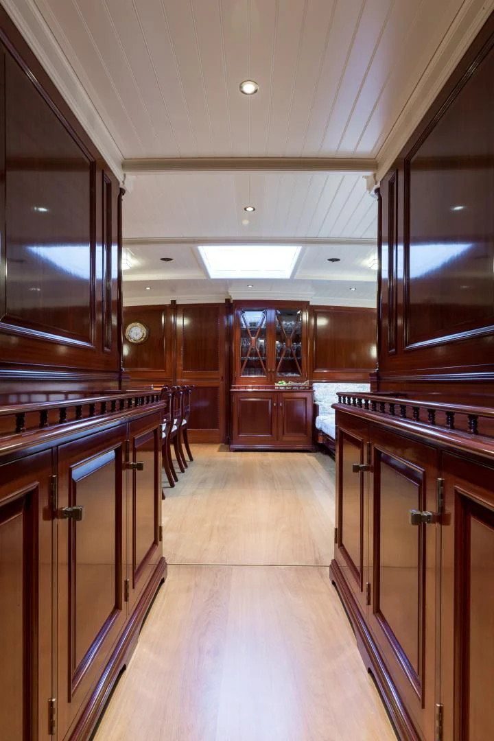a large kitchen with wooden cabinets aboard RAINBOW Yacht for Sale