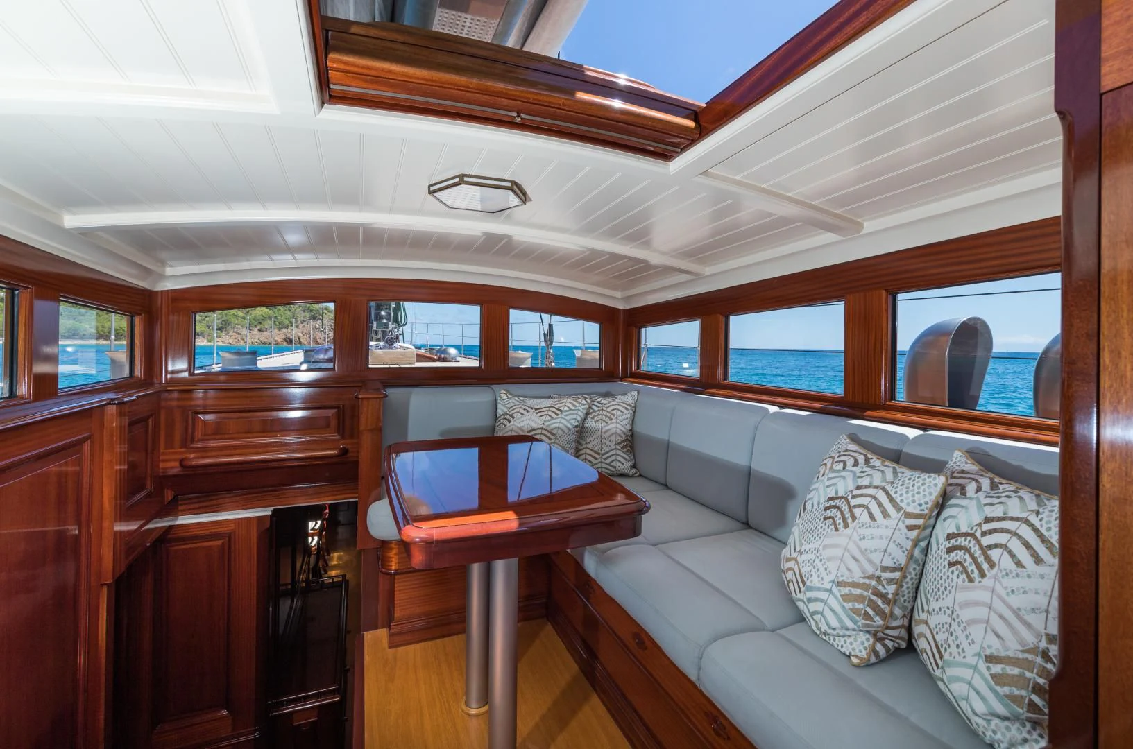 a room with a couch and a table aboard RAINBOW Yacht for Sale