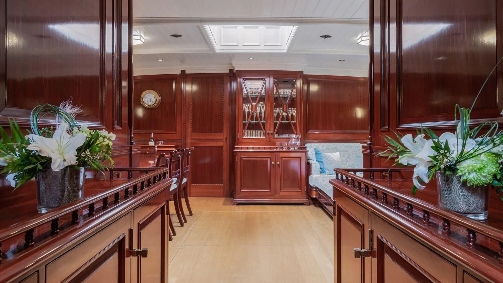 a large room with wooden cabinets aboard RAINBOW Yacht for Sale