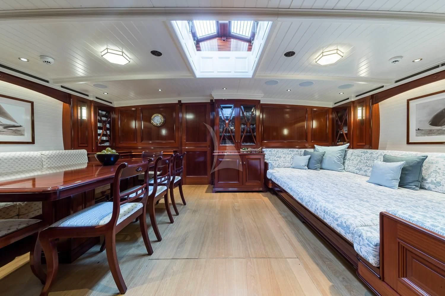 a room with a bed and a table aboard RAINBOW Yacht for Sale