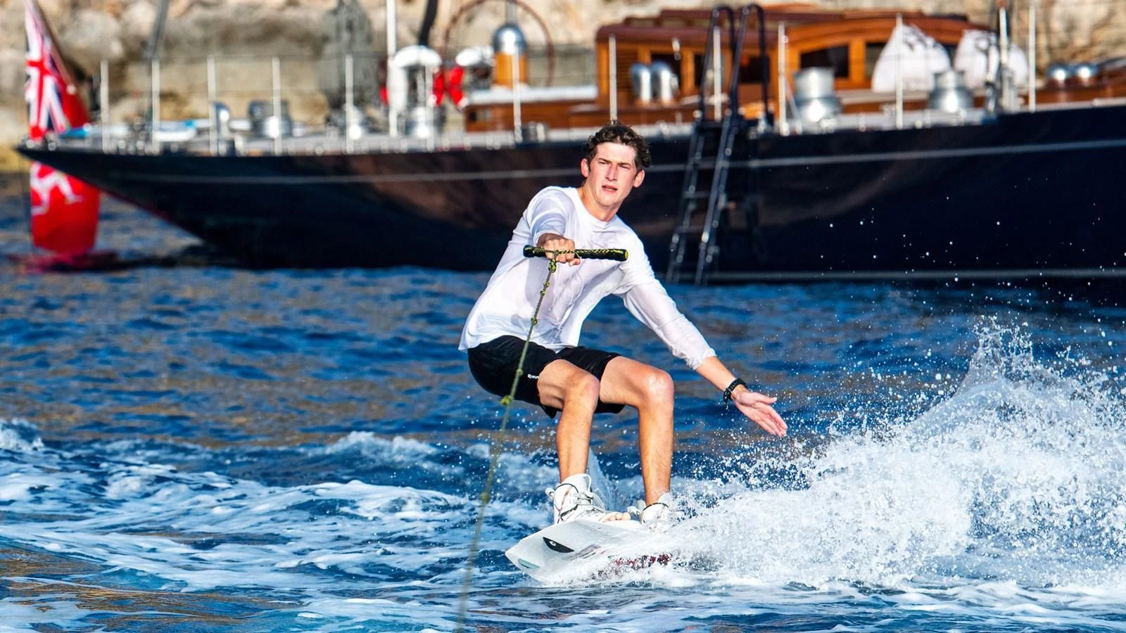 a person surfing on the waves aboard RAINBOW Yacht for Sale