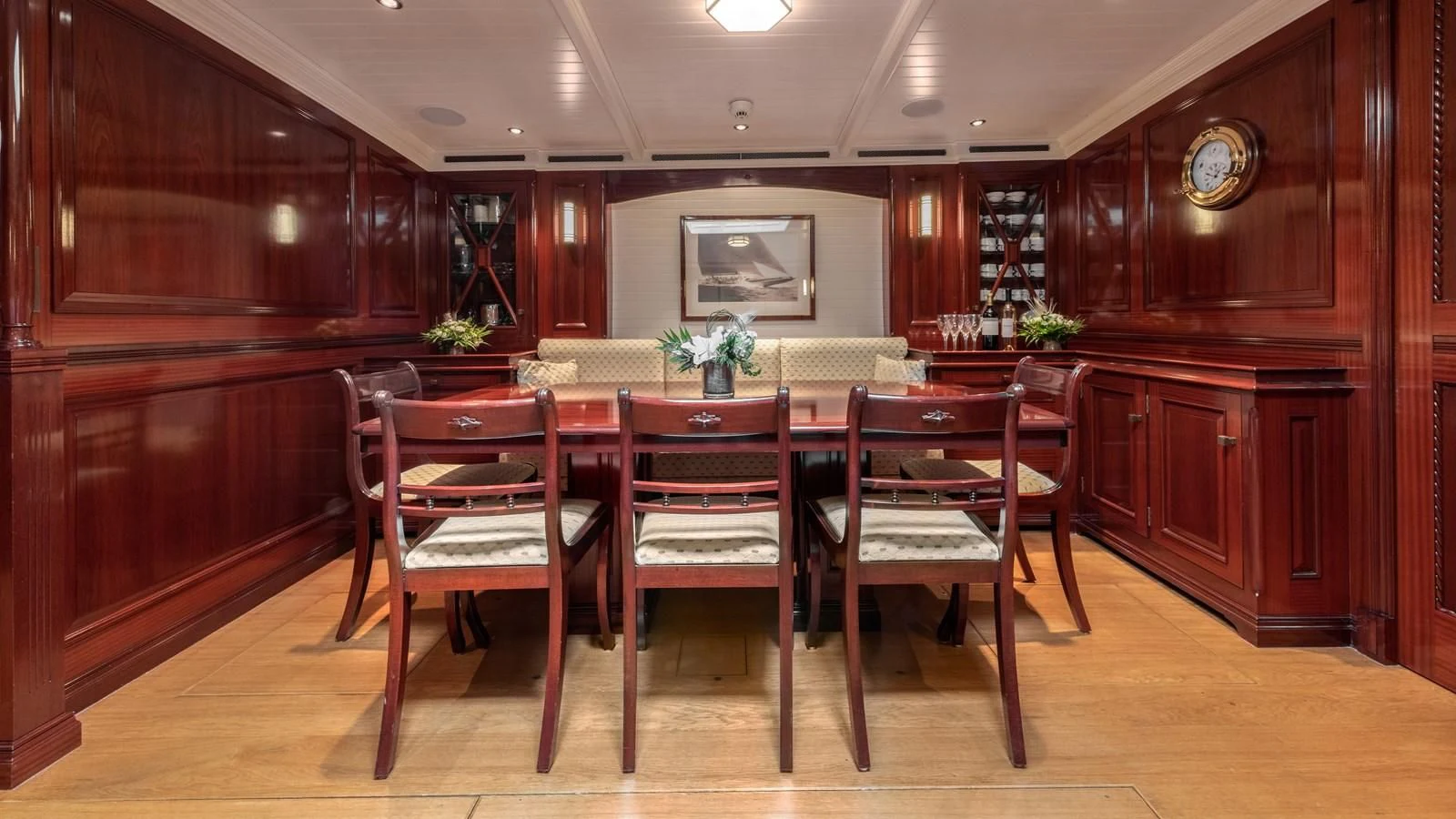 a room with a table and chairs aboard RAINBOW Yacht for Sale