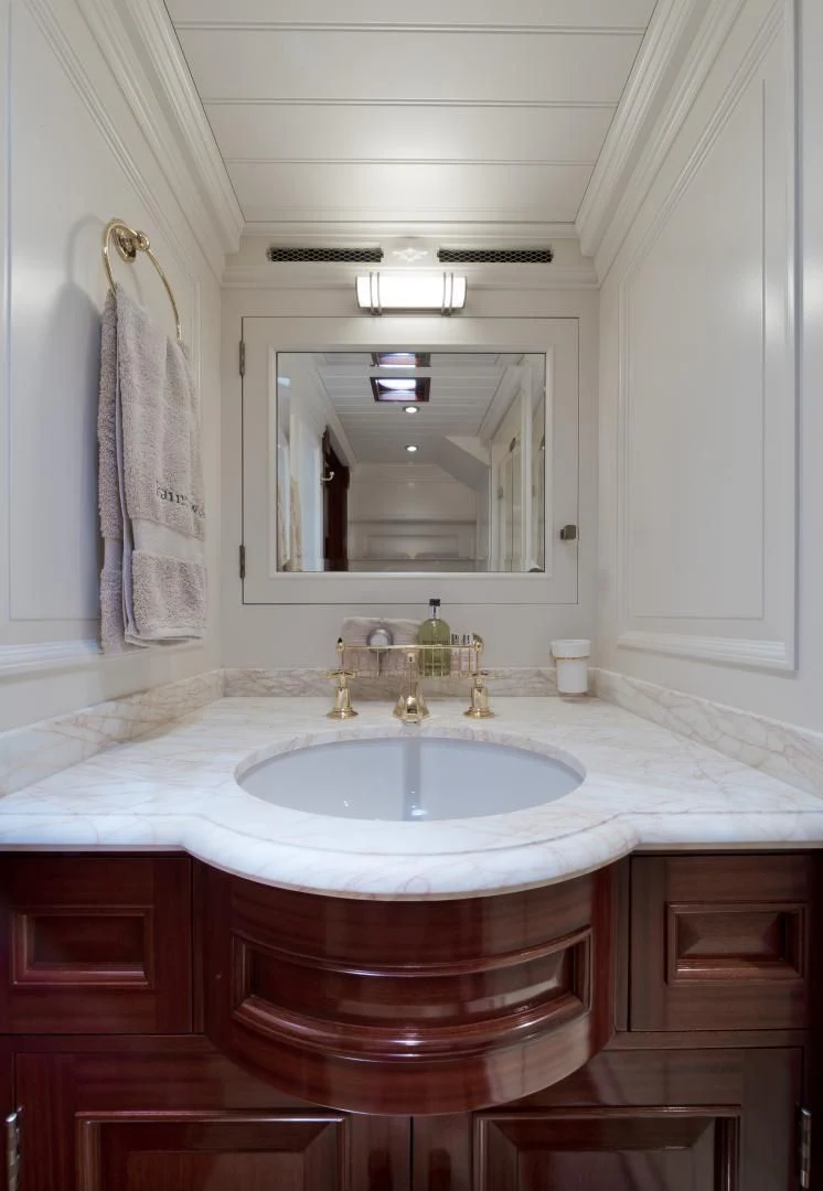 a bathroom with a sink and a mirror aboard RAINBOW Yacht for Sale