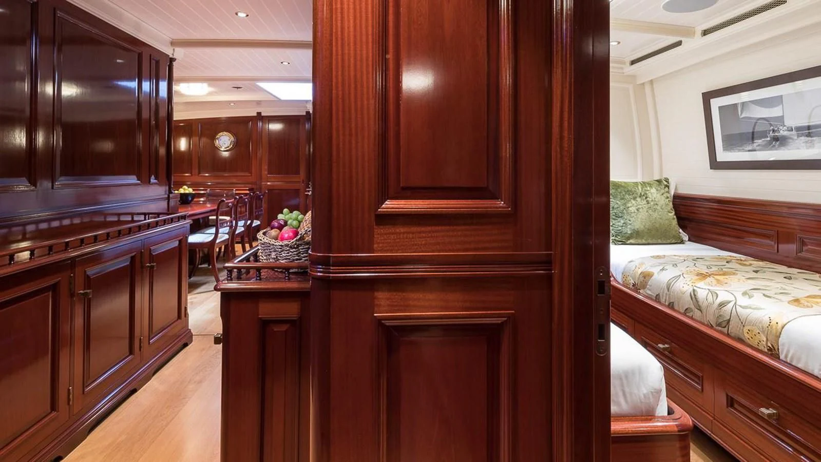 a room with wooden cabinets and a bed and a desk aboard RAINBOW Yacht for Sale