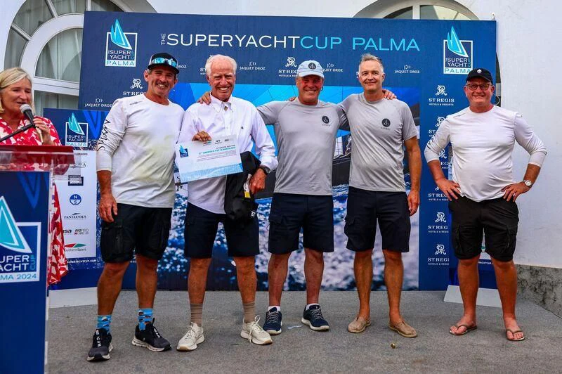 a group of men posing for a photo aboard RAINBOW Yacht for Sale