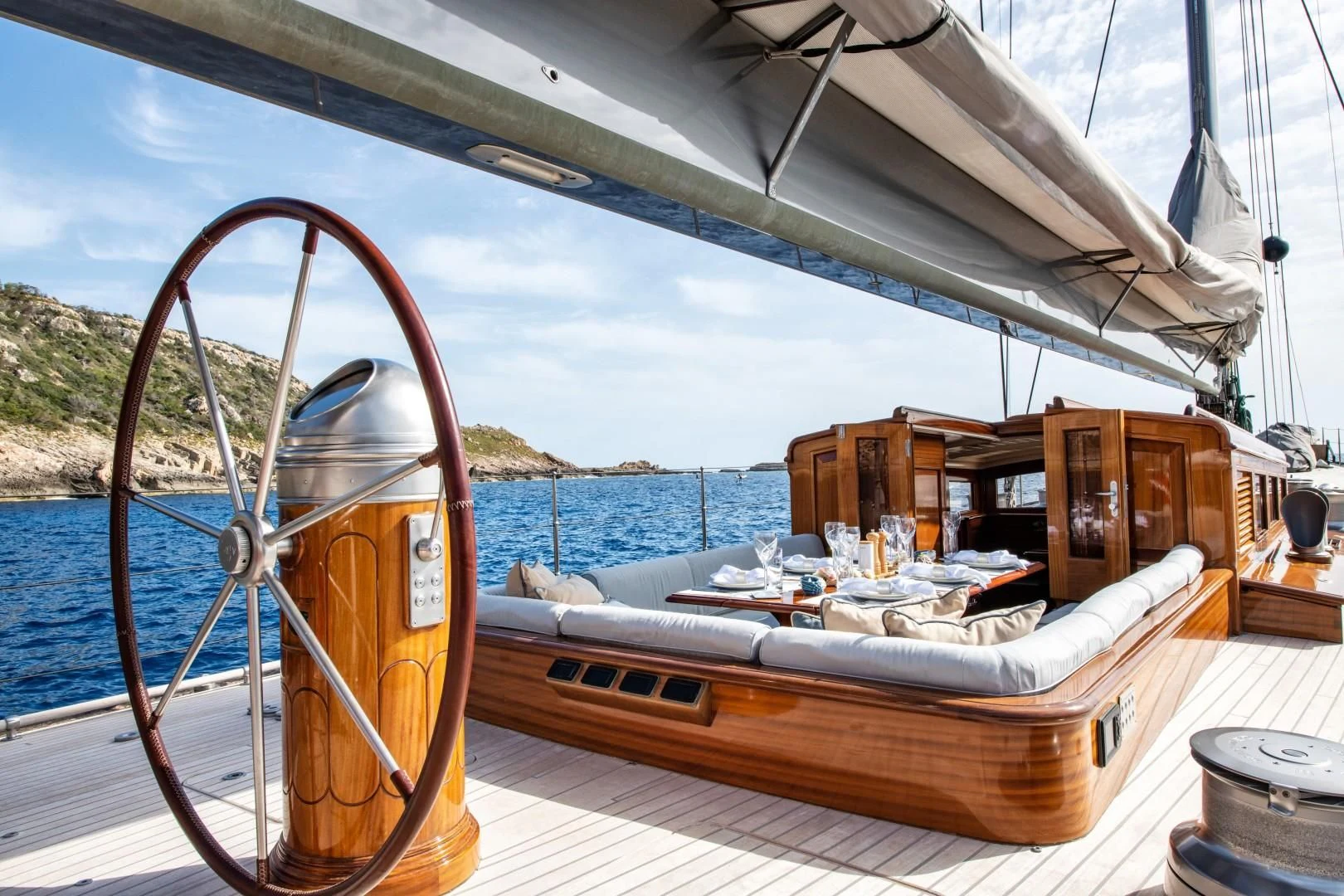 a boat with a large wheel aboard RAINBOW Yacht for Sale