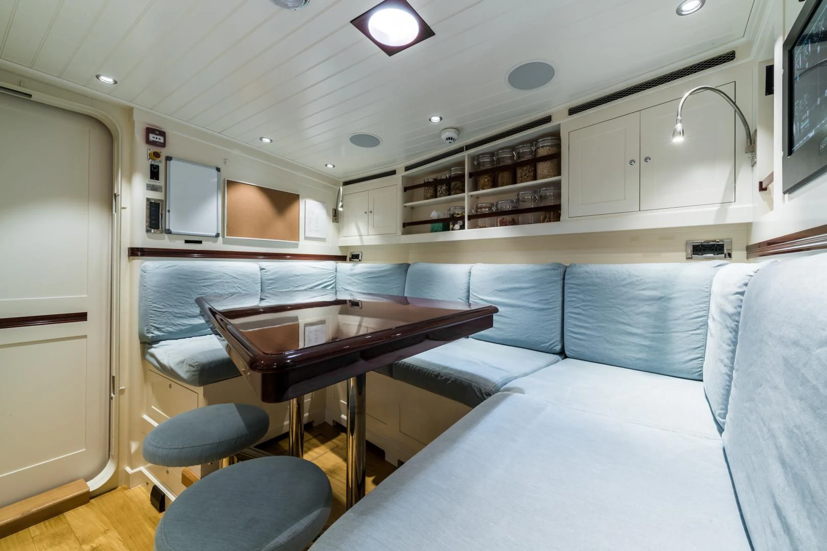 a room with a table and chairs aboard RAINBOW Yacht for Sale