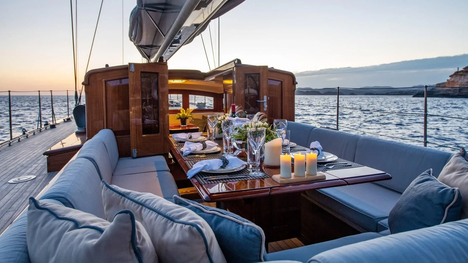 a table with candles on it on a boat aboard RAINBOW Yacht for Sale