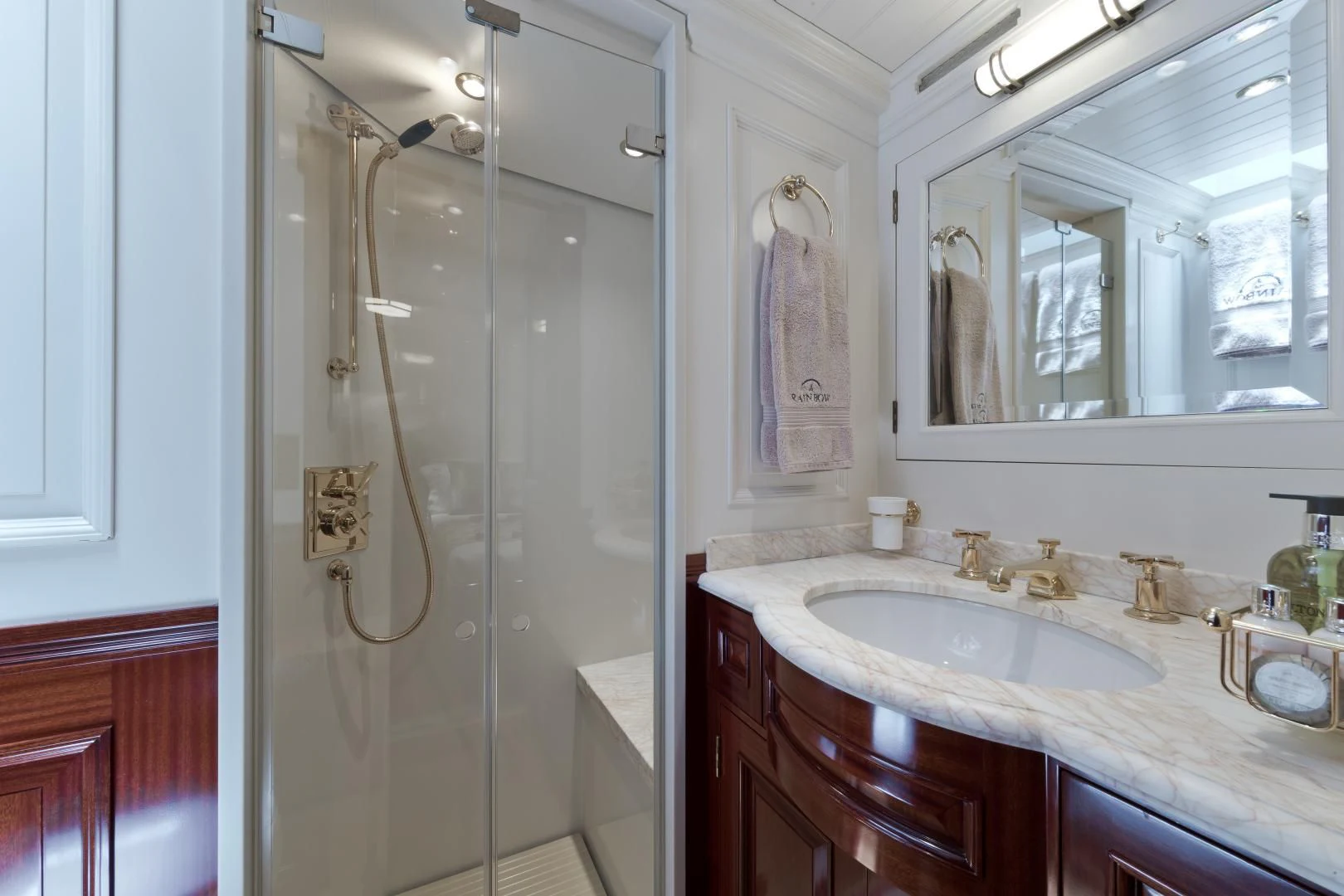 a bathroom with a shower unit and sink aboard RAINBOW Yacht for Sale