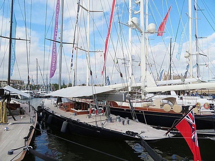 a boat docked at a pier aboard RAINBOW Yacht for Sale