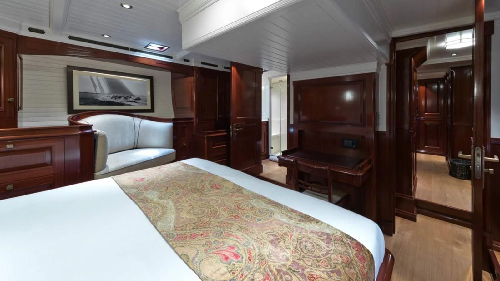 a bedroom with a bed and a desk aboard RAINBOW Yacht for Sale