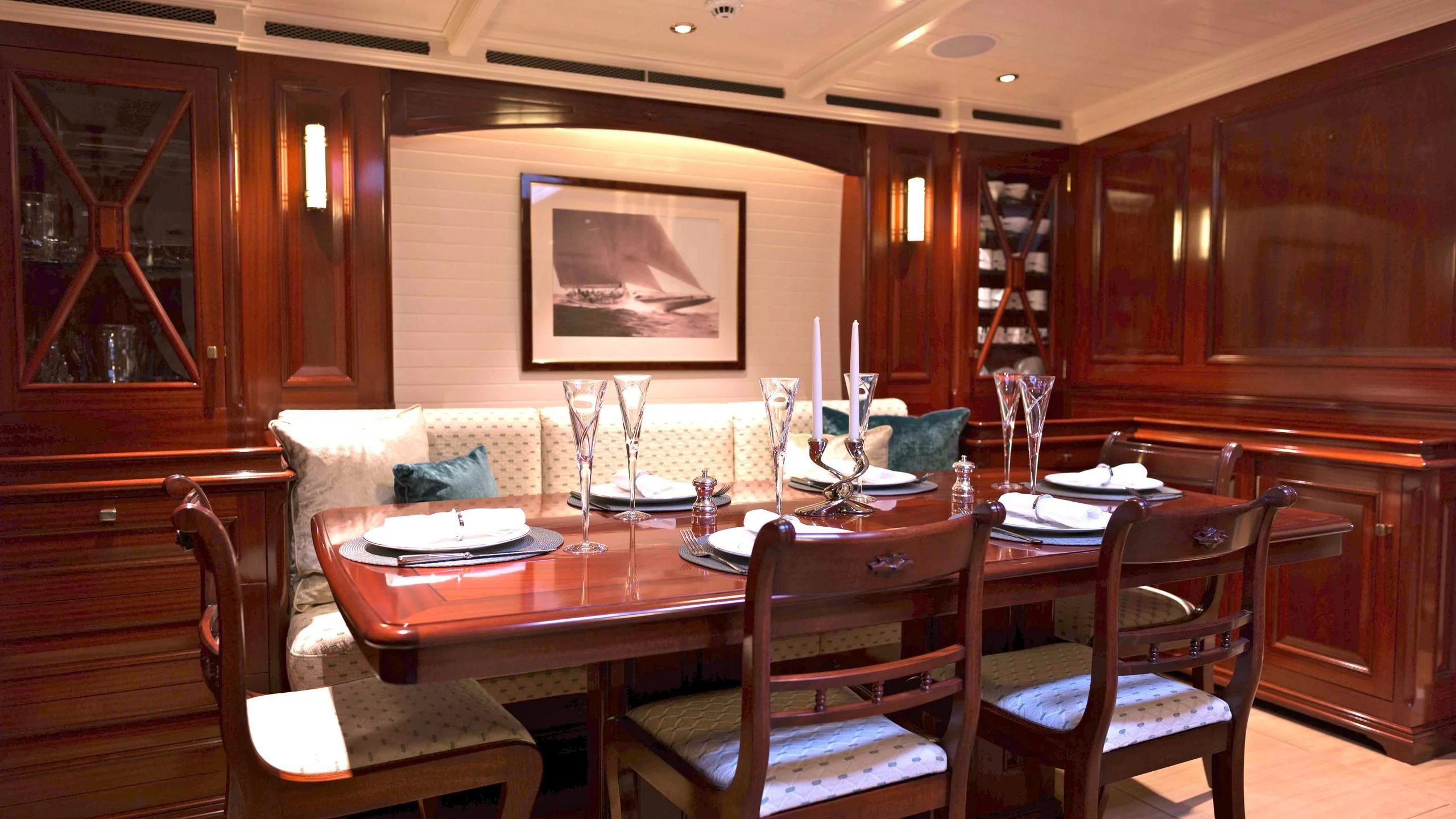 a dining room with a table and chairs aboard RAINBOW Yacht for Sale