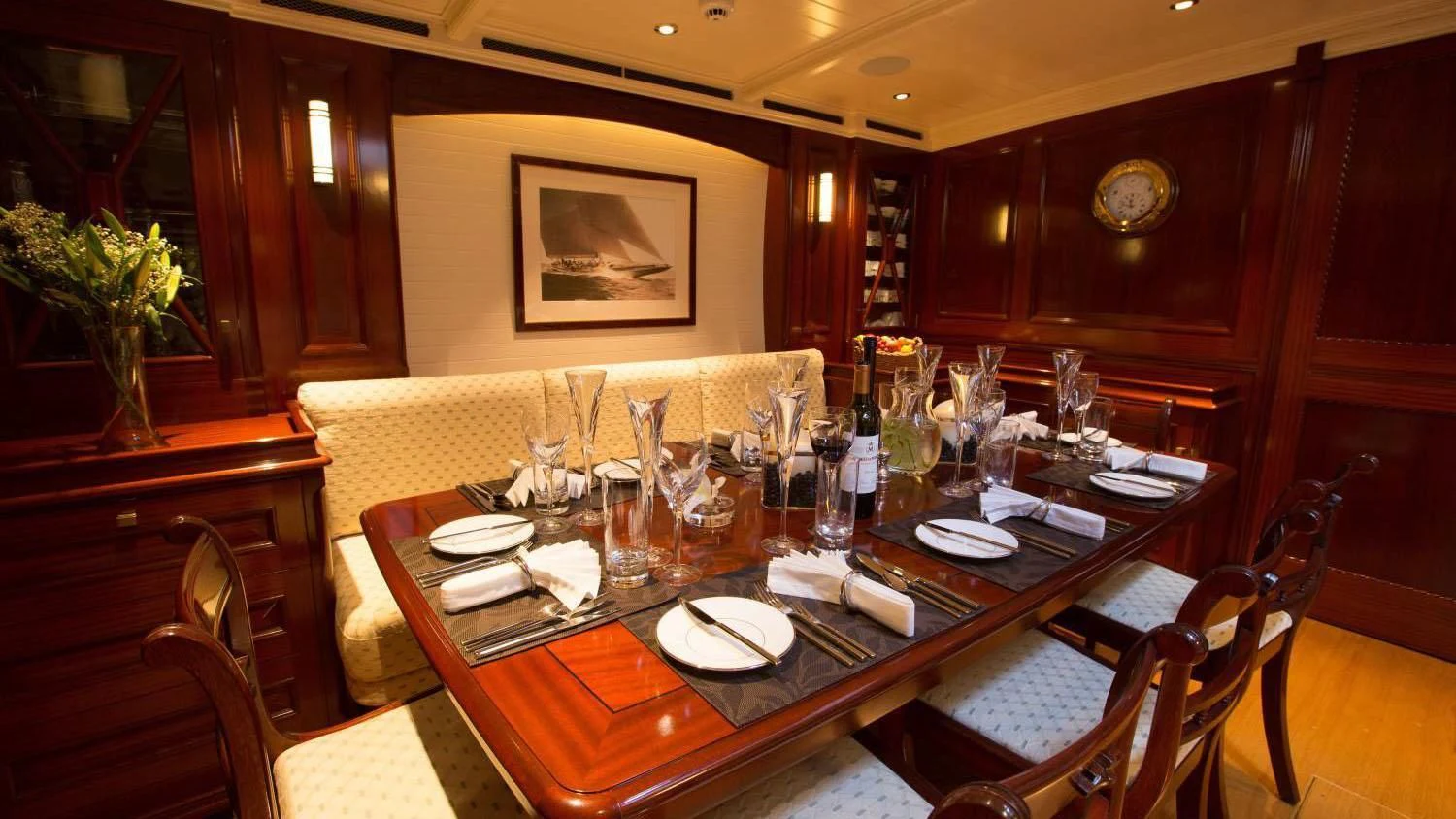 a table with plates and glasses on it aboard RAINBOW Yacht for Sale