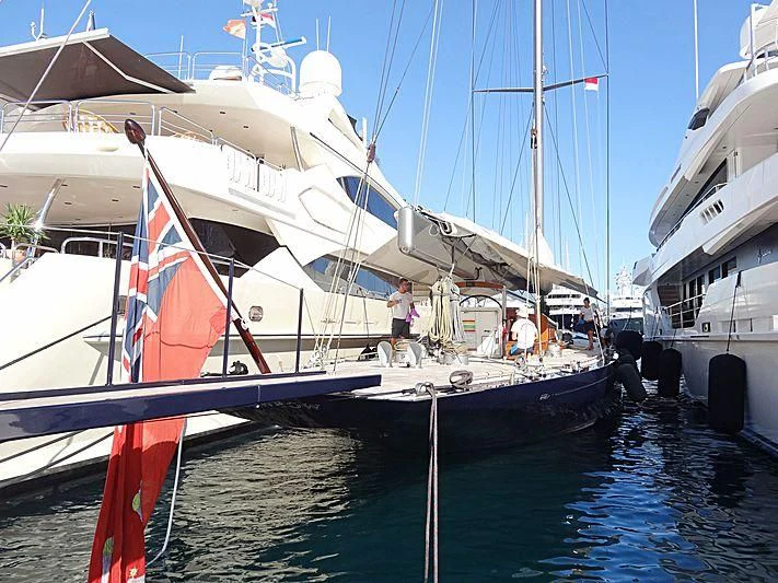 a boat with a flag on the front aboard RAINBOW Yacht for Sale
