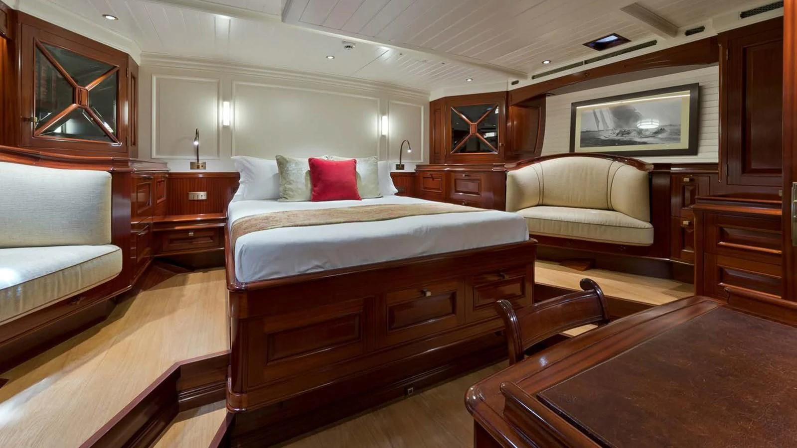 a room with a bed and a couch aboard RAINBOW Yacht for Sale