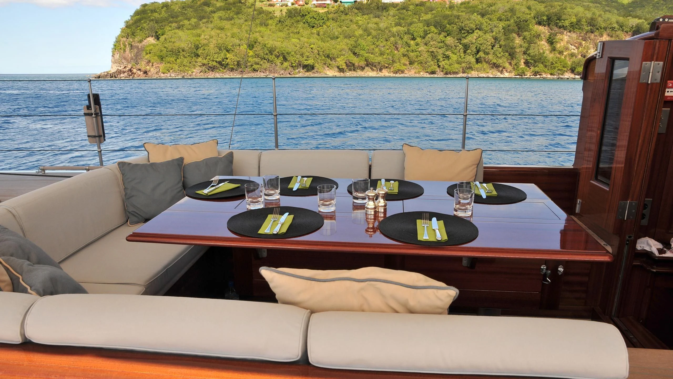 a table with a plate and a glass of wine on it aboard RAINBOW Yacht for Sale