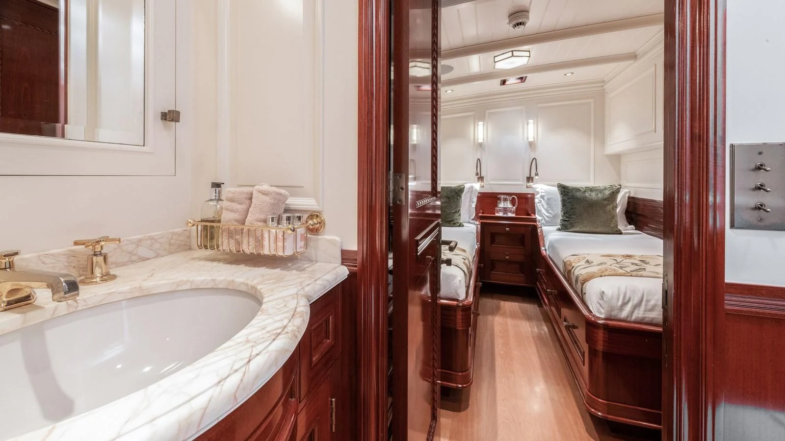 a bathroom with a sink and a bed aboard RAINBOW Yacht for Sale