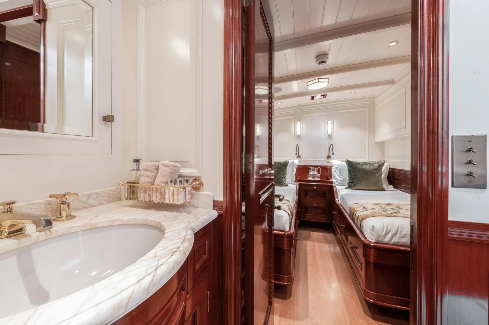 a bathroom with a sink and a bed aboard RAINBOW Yacht for Sale