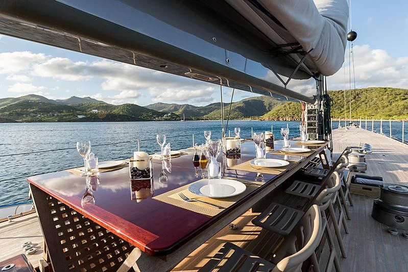 a table set for a dinner on a boat aboard RAINBOW Yacht for Sale