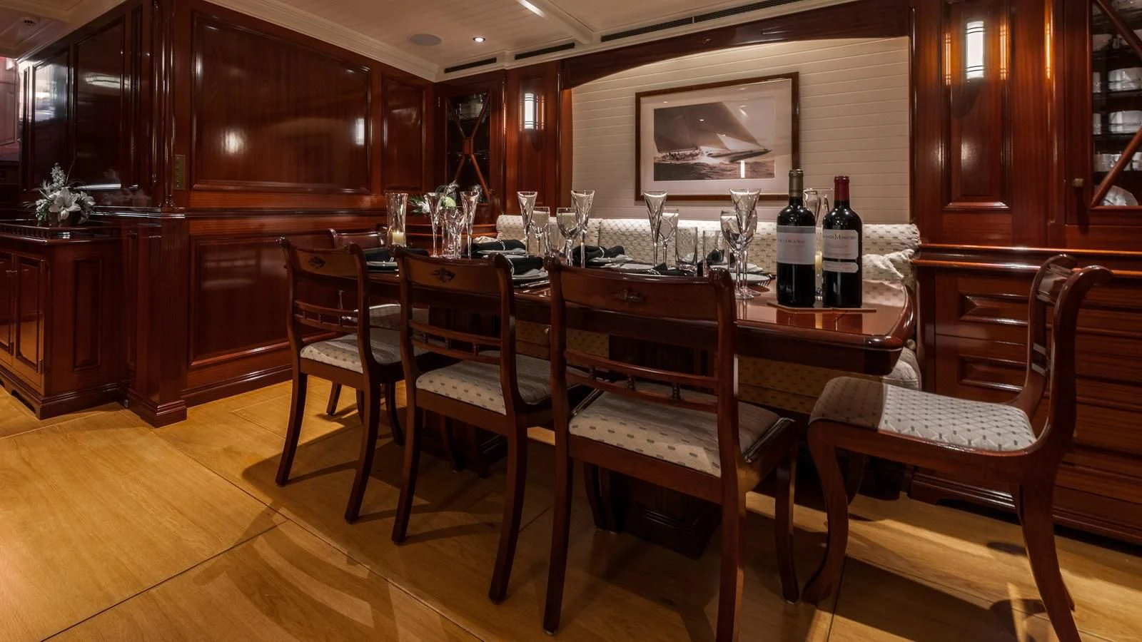 a table with wine bottles on it aboard RAINBOW Yacht for Sale