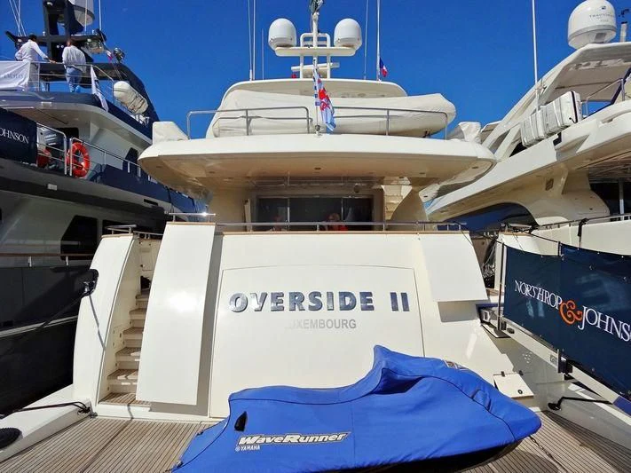 a boat docked with people on the deck aboard MAMMA MIA Yacht for Sale