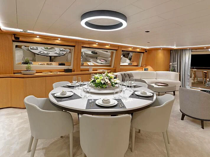 a dining room with a table set aboard MAMMA MIA Yacht for Sale