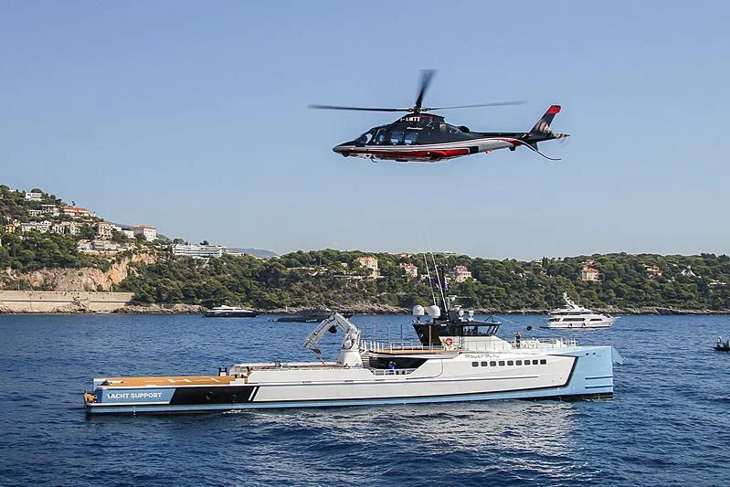 a helicopter flying over a boat aboard POWER PLAY Yacht for Sale