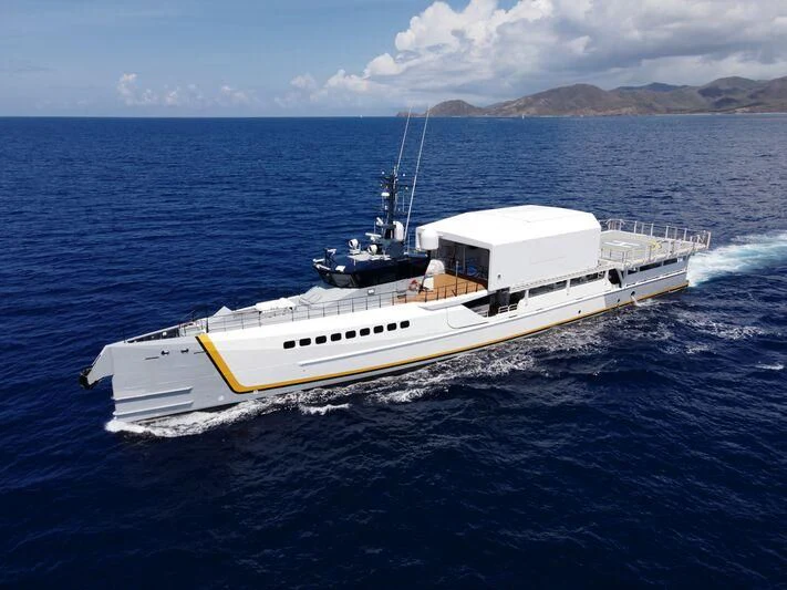 a white boat in the water aboard POWER PLAY Yacht for Sale