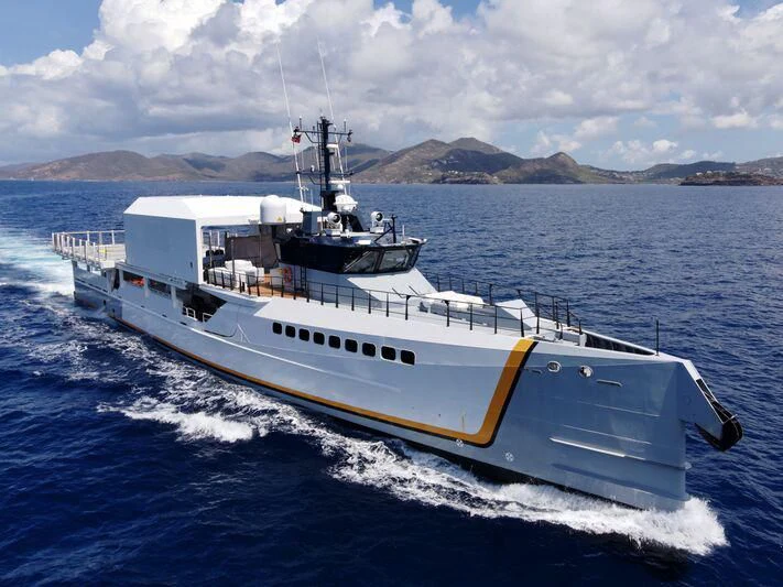 a large white boat in the water aboard POWER PLAY Yacht for Sale