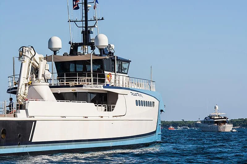 a large white boat in the water aboard POWER PLAY Yacht for Sale