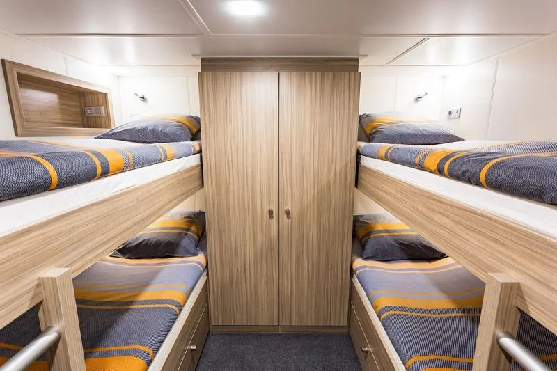 a room with bunk beds aboard POWER PLAY Yacht for Sale