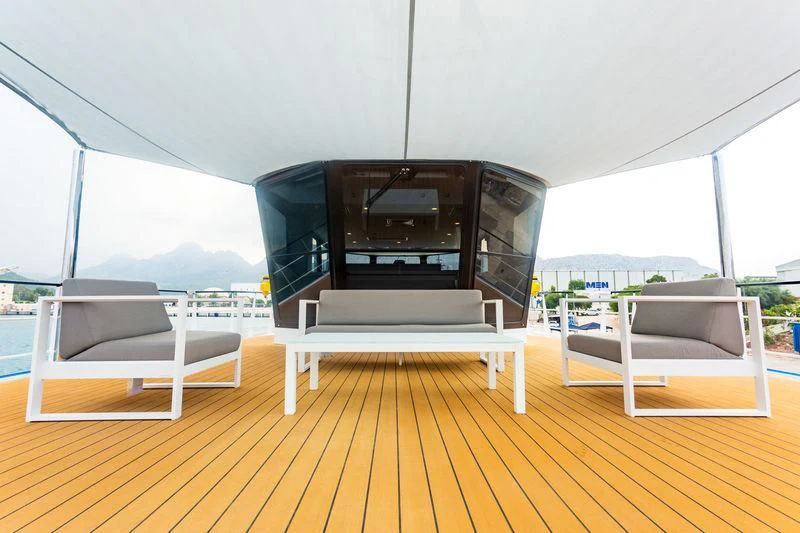 a room with a fireplace and a couch aboard POWER PLAY Yacht for Sale