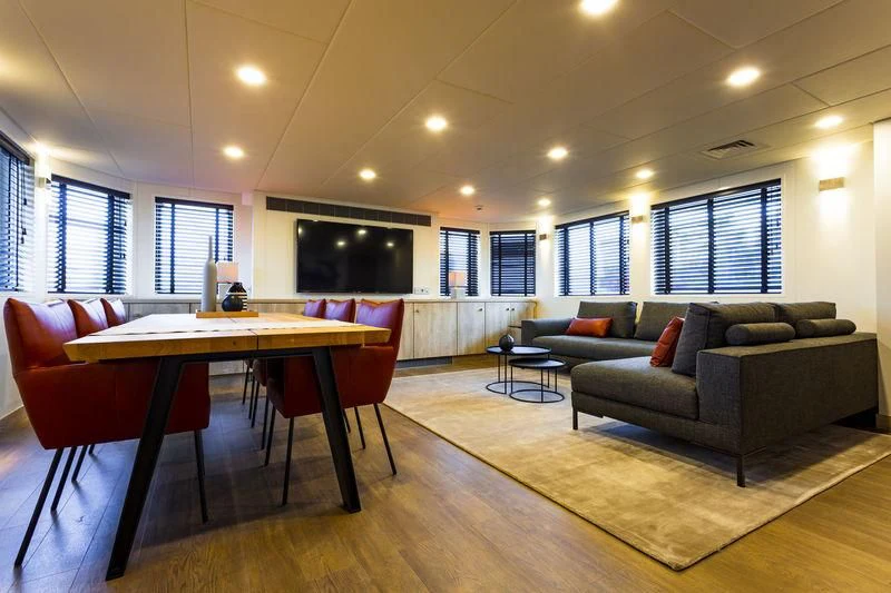 a living room with a couch and a table aboard POWER PLAY Yacht for Sale