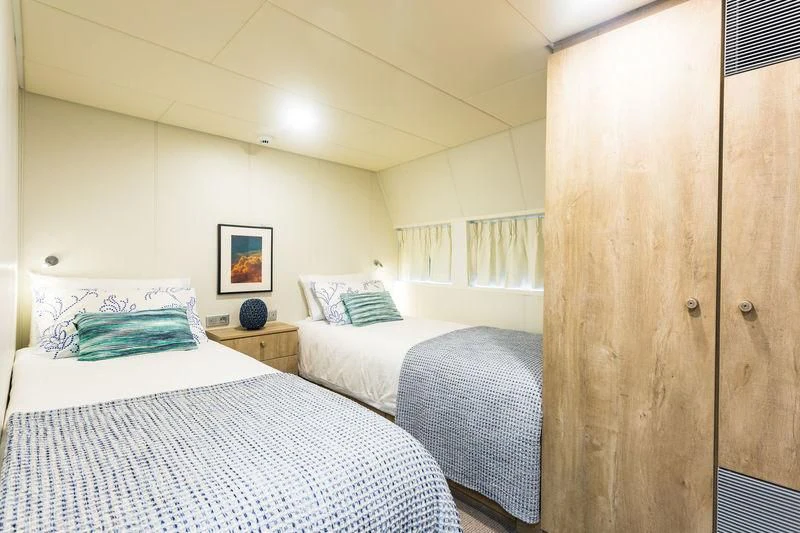 a couple of beds in a room aboard POWER PLAY Yacht for Sale