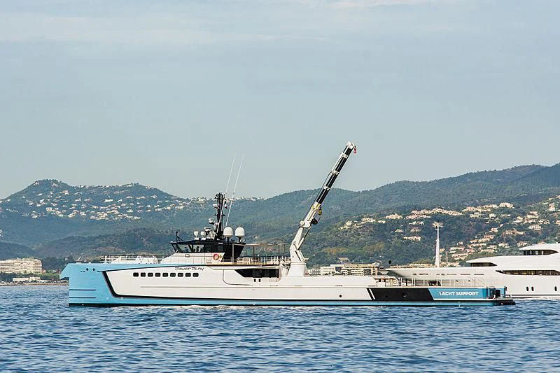 a large white boat in the water aboard POWER PLAY Yacht for Sale
