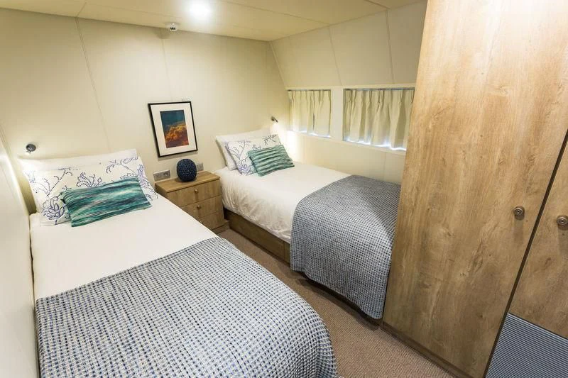 a couple of beds in a room aboard POWER PLAY Yacht for Sale