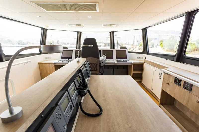 a room with a desk and chairs aboard POWER PLAY Yacht for Sale
