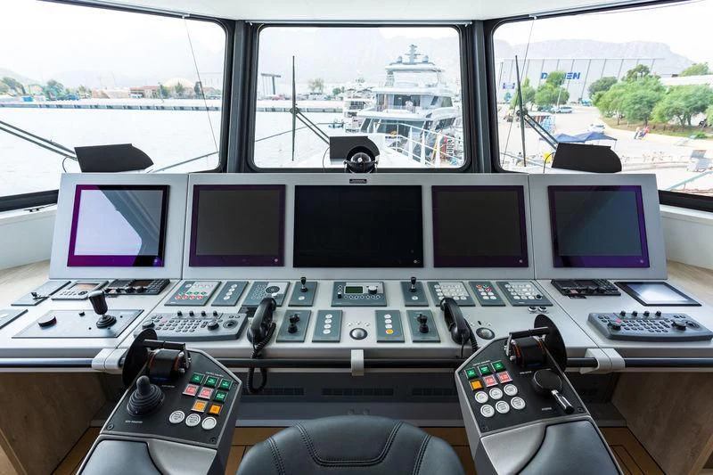 a desk with a computer and monitors aboard POWER PLAY Yacht for Sale