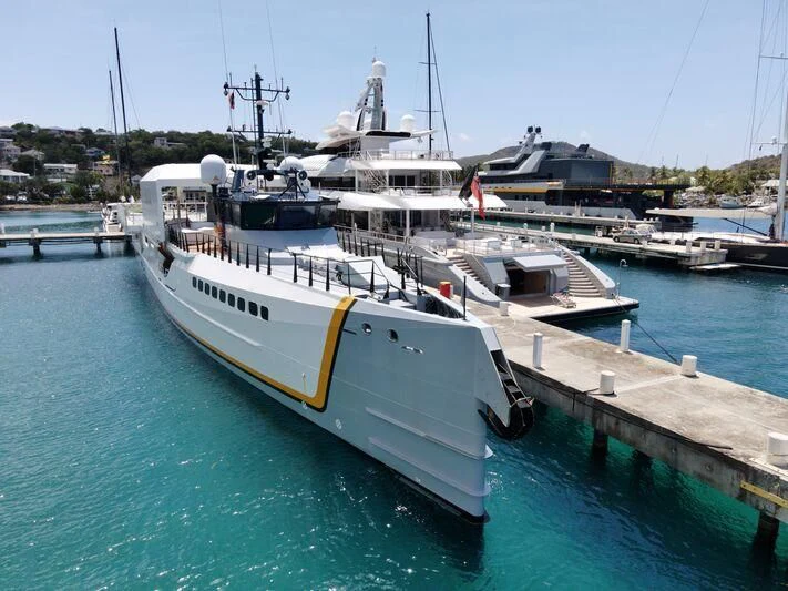 a large ship docked at a pier aboard POWER PLAY Yacht for Sale