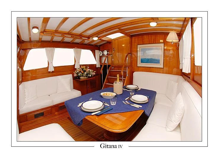 a large room with a bed and a table aboard GITANA IV Yacht for Sale