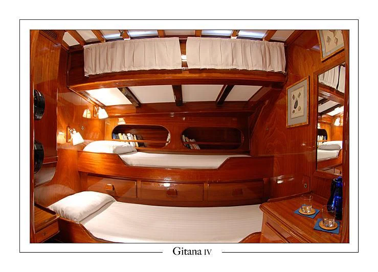 a wooden bunk bed aboard GITANA IV Yacht for Sale