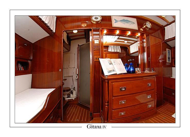 a room with a mirror and a bed aboard GITANA IV Yacht for Sale